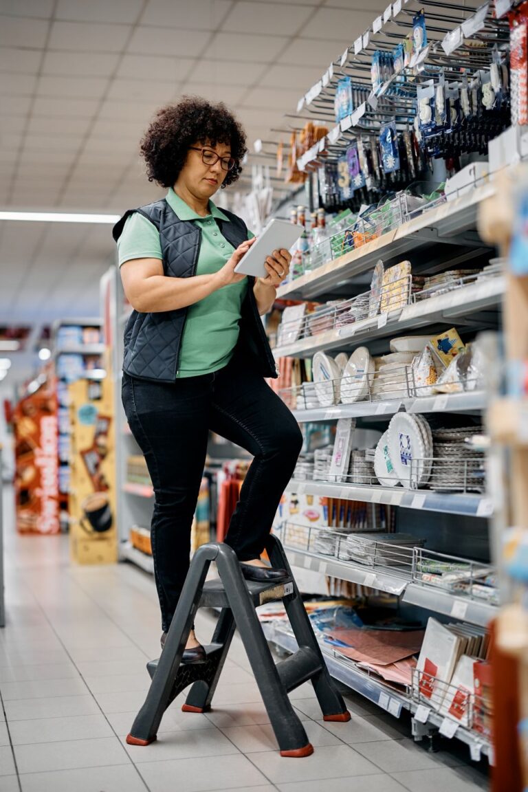 Supermarket manager working on touchpad in the store.