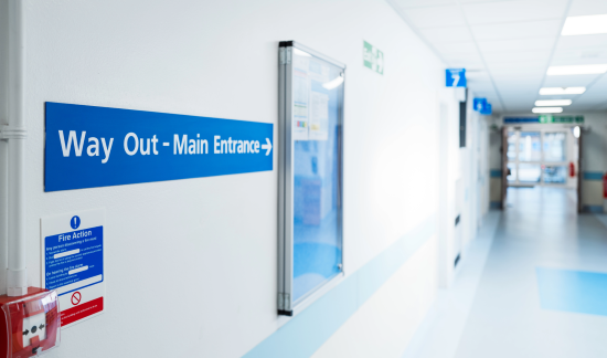 Healthcare facility exit door and hallway in Visalia showing the elopement risk pathway where patients in behavioral health and memory care units can leave undetected