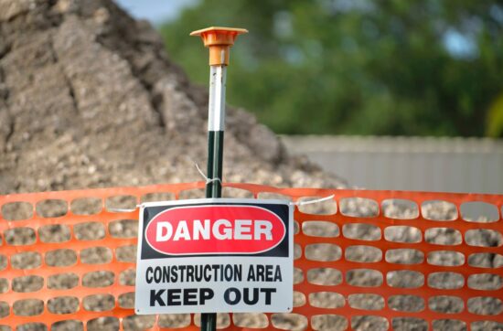 Open construction excavation at a Fresno jobsite with safety barricade fencing where after-hours trespasser injuries create premises liability exposure for contractors under California law