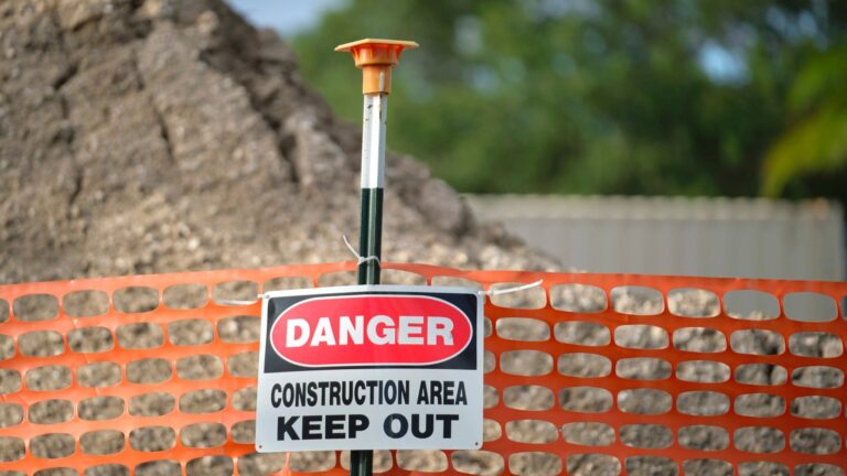 Open construction excavation at a Fresno jobsite with safety barricade fencing where after-hours trespasser injuries create premises liability exposure for contractors under California law